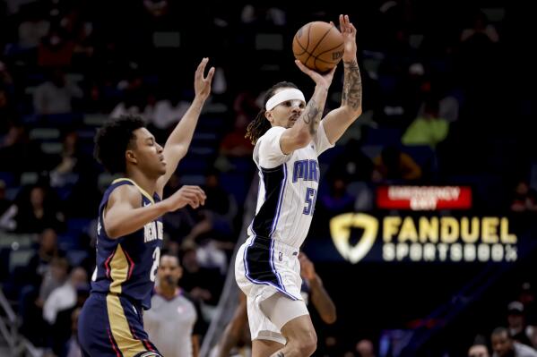 Orlando Magic guard Cole Anthony (50) shoots past New Orleans Pelicans guard Trey Murphy III (25) during the second half of an NBA basketball game in New Orleans, Wednesday, March 9, 2022. (AP Photo/Derick Hingle)