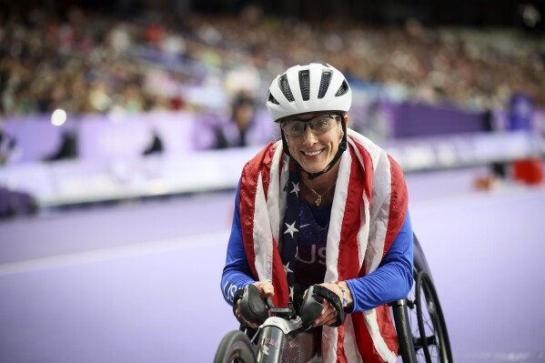 Tatyana McFadden of the U.S., celebrates before being informed she has been disqualified of the women's 400 m. T54 at the 2024 Paralympics, Sept. 5, 2024, in Paris. (AP Photo/Thomas Padilla, File)