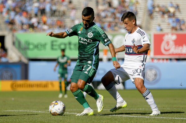 Vancouver Whitecaps FC midfielder Ryan Raposo, left, controls the ball in front of New York City FC midfielder Richard Ledezma during the first half of an MLS soccer match at Yankee Stadium, Saturday, Sept. 2, 2023, in New York. (AP Photo/John Munson)