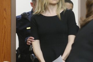 FILE - In this Feb. 14, 2013, file photo, Amy Locane enters the courtroom to be sentenced in Somerville, N.J. The former "Melrose Place" actress who has already served a prison sentence for a fatal 2010 drunken driving crash in New Jersey is headed back behind bars. A state judge on Thursday, Sept. 17, 2020, agreed with prosecutors  that Locane's previous sentences were too lenient and gave the actress an eight-year sentence. (Patti Sapone/NJ Advance Media via AP, Pool, File