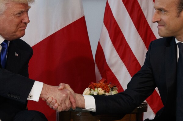 President Donald Trump shakes hands with French President Emmanuel Macron during a meeting at the U.S. Embassy, May 25, 2017, in Brussels. (AP Photo/Evan Vucci, File)
