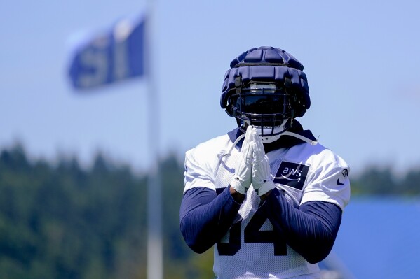 Seattle Seahawks linebacker Bobby Wagner gestures to fans as they shout his name during the NFL football team's training camp Wednesday, July 26, 2023, in Renton, Wash. (AP Photo/Lindsey Wasson)