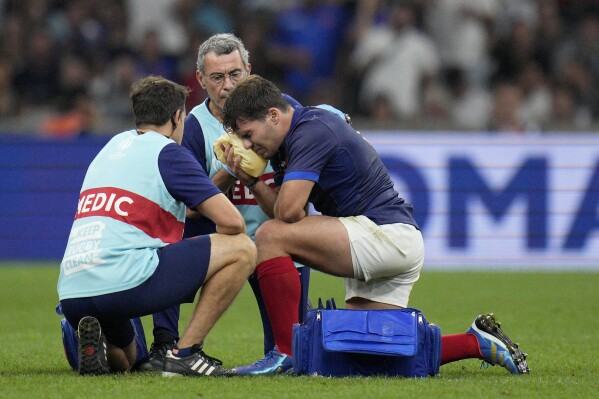 France's Antoine Dupont receives treatment after taking a knock to the head during the Rugby World Cup Pool A match between France and Namibia at the Stade de Marseille in Marseille, France, Thursday, Sept. 21, 2023. (AP Photo/Daniel Cole)