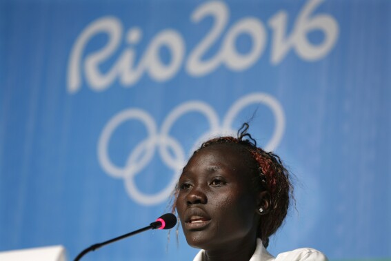 FILE - Anjelina Lohalith, a native of South Sudan and member of the Refugee Olympic Team, speaks during a press conference in Rio de Janeiro, Brazil, Sunday, July 31, 2016. Anjelina Lohalith, a third runner on the Refugee Olympic Team has been suspended for a positive doping test, announced Tuesday, April 30, 2024 two days before the IOC confirms its selection of athletes for the Paris Games. (AP Photo/Peter Morgan, File)