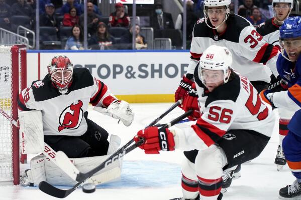 New Jersey Devils goaltender Mackenzie Blackwood (29) watches as left wing Erik Haula (56) reaches for the puck during the second period of the team's NHL hockey game against the New York Islanders, Thursday, Oct. 20, 2022, in Elmont, N.Y. (AP Photo/Julia Nikhinson)