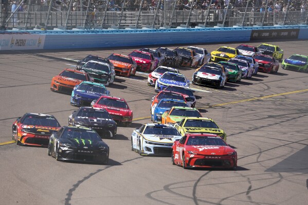 NASCAR Cup Series driver Ty Gibbs (54), left, and Denny Hamlin (11), right, start off the NASCAR Cup Series auto race at Phoenix Raceway, Sunday, March 10, 2024, in Avondale, Ariz. (AP Photo/Darryl Webb)