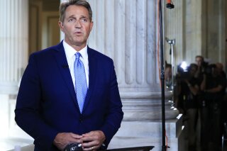 
              Sen. Jeff Flake, R-Ariz., speaks during a television interview on Capitol Hill in Washington, Tuesday, Oct. 24, 2017. Flake announced he would not run for re-election in 2018, condemning in a speech aimed at President Donald Trump the "flagrant disregard of truth and decency" that is undermining American democracy. (AP Photo/Manuel Balce Ceneta)
            