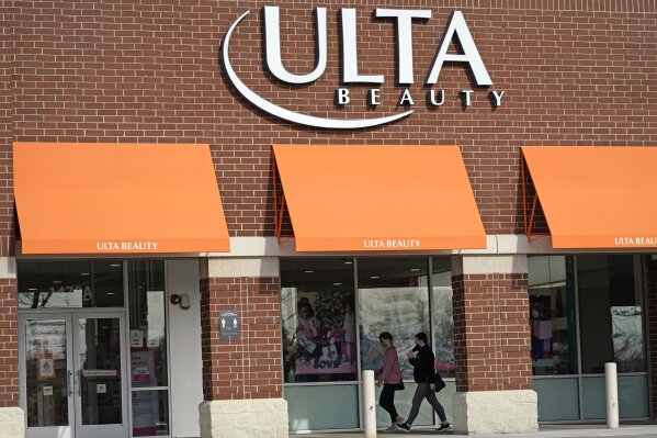 FILE - In this Nov. 5, 2020 file photo, women walk to an Ulta Beauty store in Schaumburg, Ill. Cosmetics retailer Ulta Beauty says it’s investing more than $25 million this year to improve diversity of its product mix and inclusion in its business practices. The plan announced Tuesday, Feb. 2, 2021, includes doubling the number of beauty products from Black-owned brands by year-end, though it declined to say the number.  (AP Photo/Nam Y. Huh, File)
