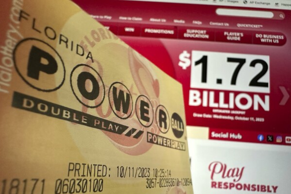 A Powerball lottery ticket is shown, Wednesday, Oct. 11, 2023, in Surfside, Fla. After 35 straight drawings without a big winner, Powerball players are lining up for a shot at a near-record jackpot worth an estimated $1.73 billion. (AP Photo/Wilfredo Lee)