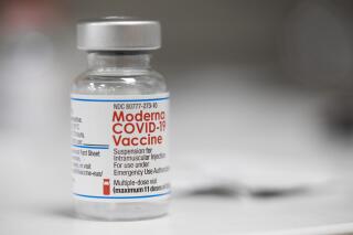 FILE - A vial of the Moderna COVID-19 vaccine is displayed on a counter at a pharmacy in Portland, Ore. on Dec. 27, 2021. Social media posts in recent days have amplified a false claim about the animal studies conducted for COVID-19 vaccines. (AP Photo/Jenny Kane, File)