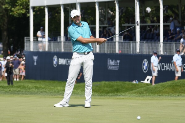 Scottie Scheffler reacts to missing a birdie putt on the ninth hole during the final round of the BMW Championship golf tournament, Sunday, Aug. 20, 2023, in Olympia Fields, Ill. (AP Photo/Charles Rex Arbogast)