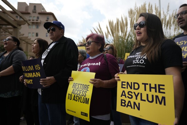 Demonstrators gather outside of the Richard H. Chambers U.S. Court of Appeals ahead of an asylum hearing, Tuesday, Nov. 7, 2023, in Pasadena, Calif. (AP Photo/Marcio Jose Sanchez)