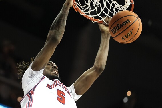 Houston forward Ja'Vier Francis dunks the ball during the second half of an NCAA college basketball game against Texas Tech in the semifinal round of the Big 12 Conference tournament, Friday, March 15, 2024, in Kansas City, Mo. Houston won 82-59. (AP Photo/Charlie Riedel)