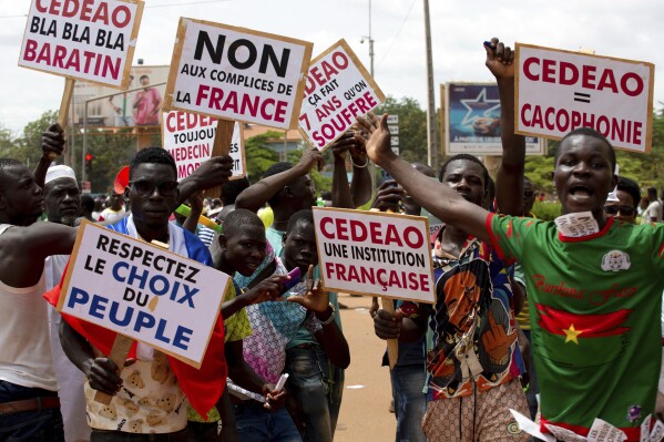 FILE - Supporters of Capt. Ibrahim Traore protest against France and the West African regional bloc known as ECOWAS in the streets of Ouagadougou, Burkina Faso, Oct. 4, 2022. In Sept. 2023, The era of France's arm-twisting interventionism in Africa may finally be over. France has sat by militarily despite moves by putschists to seize control of former French colonies in recent years. (AP Photo/Kilaye Bationo, File)