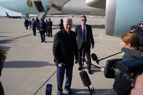 President Joe Biden speaks to members of the media as he arrives at Milwaukee Mitchell International Airport, Wednesday, Dec. 20, 2023, in Milwaukee. (AP Photo/Evan Vucci)