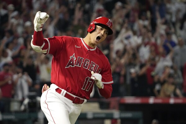 FILE - Los Angeles Angels' Shohei Ohtani celebrates as he rounds first after hitting a two-run home run during the seventh inning of a baseball game against the New York Yankees Monday, July 17, 2023, in Anaheim, Calif. Shohei Ohtani is a favorite to win his second AL Most Valuable Player award, Thursday, Nov. 16, 2023. (AP Photo/Mark J. Terrill, File)