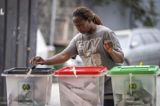 A woman casts her vote at a polling station in Lagos, Nigeria Saturday, Feb. 25, 2023. Voters in Africa's most populous nation are heading to the polls Saturday to choose a new president, following the second and final term of incumbent Muhammadu Buhari. (AP Photo/Ben Curtis)