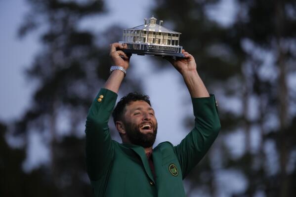 Jon Rahm, of Spain, celebrates holding the Masters trophy winning the Masters golf tournament at Augusta National Golf Club on Sunday, April 9, 2023, in Augusta, Ga.(AP Photo/David J. Phillip)