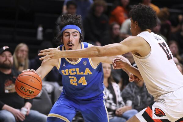 UCLA guard Jaime Jaquez Jr. (24) is defended by Oregon State forward Michael Rataj (12) during the second half of an NCAA college basketball game in Corvallis, Ore., Thursday, Feb. 9, 2023. UCLA won 62-47. (AP Photo/Amanda Loman)
