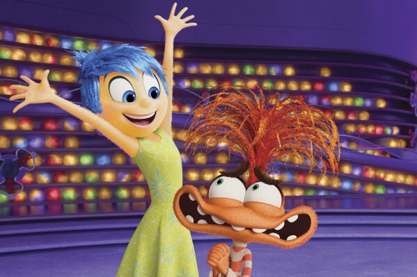 This image released by Disney/Pixar shows Joy, voiced by Amy Poehler, left, and Anxiety, voiced by Maya Hawke, in a scene from 