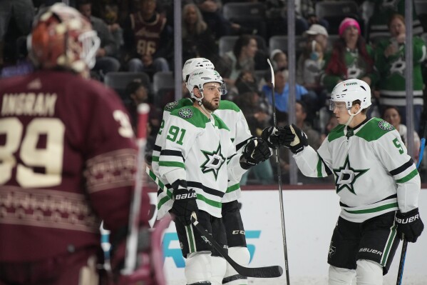 Dallas Stars center Tyler Seguin celebrates with defenseman Nils Lundkvist after scoring a goal on Arizona Coyotes goaltender Connor Ingram in the second period during an NHL hockey game, Sunday, March 24, 2024, in Tempe, Ariz. (AP Photo/Rick Scuteri)