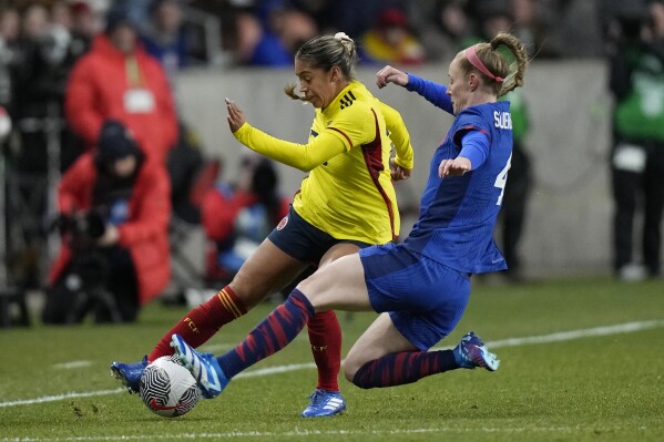 U.S. defender Becky Sauerbrunn (4) defends against Colombia forward Elexa Bahr during the second half of an international friendly soccer match Thursday, Oct. 26, 2023, in Sandy, Utah. (AP Photo/Rick Bowmer)