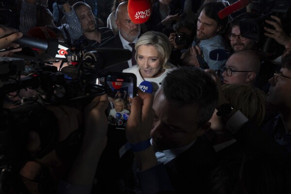 Far-right National Rally party leader Marine Le Pen answers reporters after the second round of the legislative election, July 7, 2024, at the party election night headquarters in Paris. (AP Photo/Louise Delmotte, File)