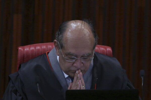 
              Superior Electoral Court President Gilmar Mendes listens in during the judgment phase of a trial involving allegations that the 2014 Rousseff-Temer ticket received illegal campaign financing in Brasilia, Brazil, Wednesday, June 7, 2017. Brazil's top electoral court is returning to its examination of illegal campaign finance allegations that could force President Michel Temer from office. (AP Photo/Eraldo Peres)
            