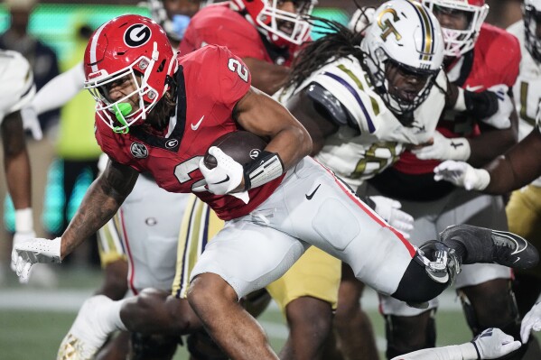 Georgia running back Kendall Milton (2) runs for a touchdown during the first half of an NCAA college football game against Georgia Tech, Saturday, Nov. 25, 2023, in Atlanta. (AP Photo/John Bazemore)