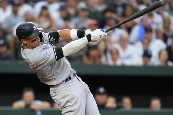New York Yankees' Aaron Judge follows through on a swing as he hits a two-run home run off Baltimore Orioles starting pitcher Tyler Wells during the third inning of a baseball game, Saturday, July 29, 2023, in Baltimore. Yankees' Kyle Higashioka also scored on the home run. (AP Photo/Julio Cortez)