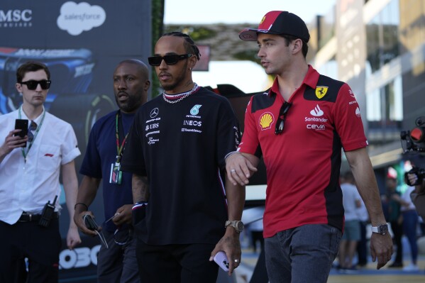 FILE - Mercedes driver Lewis Hamilton of Britain, left, and Ferrari driver Charles Leclerc of Monaco arrive to speak to media ahead of the Formula On Saudi Arabian Grand Prix in Jeddah, Saudi Arabia, Thursday, March 16, 2023. Lewis Hamilton's arrival will present “a huge opportunity” for Ferrari next year but signing the seven-time Formula One champion involved some uncomfortable phone calls, team principal Fred Vasseur said Tuesday, Feb. 13, 2024. Hamilton is joining Ferrari for next season after driving for Mercedes since 2013. He will team up with Charles Leclerc at the Italian team after Carlos Sainz Jr. leaves. (AP Photo/Hassan Ammar, File)