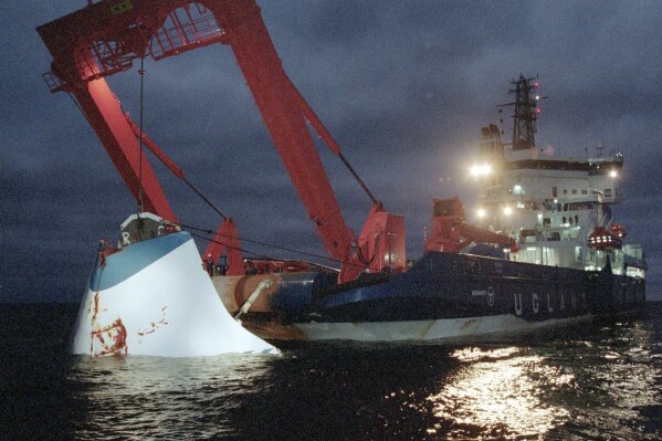 FILE - In this Nov. 19, 1994 file photo, the bow door of the sunken passenger ferry M/S Estonia is lifted up from the bottom of the sea, off Uto Island, in the Baltic Sea. Swedish authorities say they will not reopen the case of a 1994 ferry sinking in the Baltic Sea that killed 852 people, in one of Europe’s deadliest peacetime disasters at sea. (Jaakko Aiikainen/Lehtikuva via AP, File)