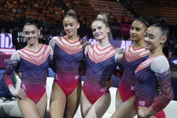 FILE - Second place Britain's team celebrates after the women's team final during the European Gymnastics Championships in Munich, Germany, Saturday, Aug. 13, 2022. The head Great Britain’s women’s artistic gymnastics has stepped down on the eve of the European Championships in Italy and less than 100 days before the Paris Olympics. (AP Photo/Matthias Schrader, File)