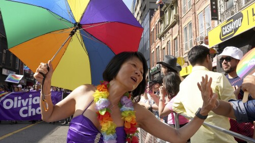 Toronto mayoral candidate Olivia Chow high-fives a spectator as she walks in the Toronto Pride Parade, Sunday June 25, 2023. (Chris Young/The Canadian Press via AP)