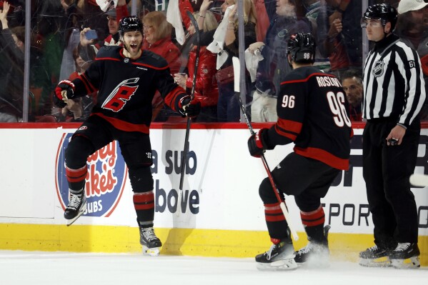 Carolina Hurricanes' Taylor Hall (71) celebrates his goal with teammate Jack Roslovic (96) during the third period of Game 4 of second-round playoff series against the Washington Capitals in Raleigh, N.C., Monday, May 12, 2025. (AP Photo/Karl DeBlaker)