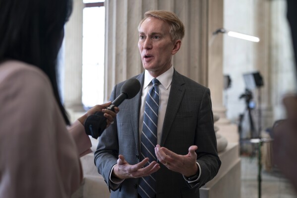 Sen. James Lankford, R-Okla., the lead GOP negotiator on the Senate border and foreign aid package, does a TV news interview on Capitol Hill at the Capitol in Washington, Monday, Feb. 5, 2024. (AP Photo/J. Scott Applewhite)