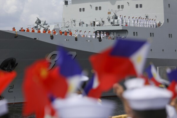 Chinese navy sailors wave as they arrive on board their naval training ship, Qi Jiguang, for a goodwill visit at Manila's port, Philippines Wednesday, June 14, 2023. The Chinese navy training ship made a port call in the Philippines on Wednesday, its final stop on a goodwill tour of four countries as Beijing looks to mend fences in the region. (AP Photo/Basilio Sepe)