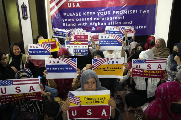 Afghan refugees hold an indoor rally to demand their U.S. visa to be processed in Islamabad, Pakistan, Friday, July 21, 2023. When the U.S. pulled out of Afghanistan in August 2021, it carried tens of thousands of Afghans to safety. But two years later, many others are still waiting to be resettled. Those are Afghans who helped the war effort by working with the U.S. government and military or Afghan journalists and aid workers whose former work puts them at risk under the Taliban. (AP Photo/Rahmat Gul)