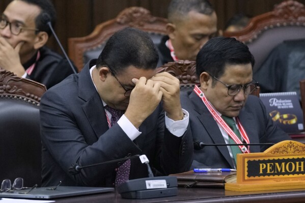 Presidential candidate Anies Baswedan, left, and his running mate Muhaimin Iskandar react during their election appeal hearing at the Constitutional Court in Jakarta, Indonesia, Monday, April 22, 2024. The country's top court on Monday rejected appeals lodged by two losing presidential candidates who are demanding a revote, alleging widespread irregularities and fraud at the February polls. (AP Photo/Dita Alangkara)