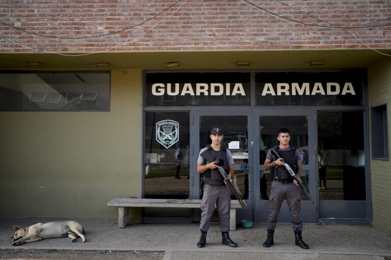 Prison guards stand inside the Pinero jail complex in Pinero, Argentina, Tuesday, April 9, 2024. President Javier Milei has called for harsher penalties against drug traffickers and military intervention. (AP Photo/Natacha Pisarenko)