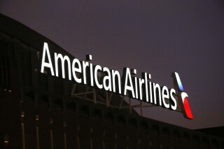 FILE - The American Airlines logo is seen atop the American Airlines Center, Dec. 19, 2017, in Dallas. An American Airlines jetliner that suffered an “anomaly” in the braking system before running past the end of a runway in Texas last month had undergone a brake-replacement job four days earlier, U.S. investigators said Thursday, March 21, 2024. (AP Photo/Michael Ainsworth, File)