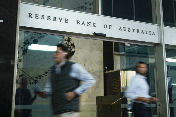 People walk out of the Reserve Bank building in the central business district in Sydney, Australia, Tuesday, Nov. 7, 2023. Australia's central bank has lifted interest rates for the first time in five months, taking the official cash rate up by a quarter of a percentage point to 4.35 per cent. Australia’s central bank lifted its benchmark interest rate Tuesday for the first time since June with a quarter percentage point hike that brought the cash rate to a 12-year high of 4.35%. (AP Photo/Mark Baker)