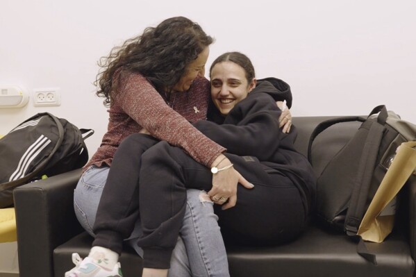 romi gonen, right, and her mother merav hold each other near kibbutz reim, southern israel after romi was released from captivity by hamas militants in gaza, sunday, jan. 19, 2025. (israeli army via ap)