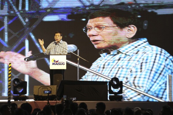 Former Philippine President Rodrigo Duterte gestures during his speech in Davao, southern Philippines late Sunday Jan. 28, 2024. Former President Duterte is throwing allegations at his successor, Fernando Marcos Jr., and even raising the prospect of removing him from office, bringing into the open a long-rumored split between the two.(AP Photo/Manman Dejeto)