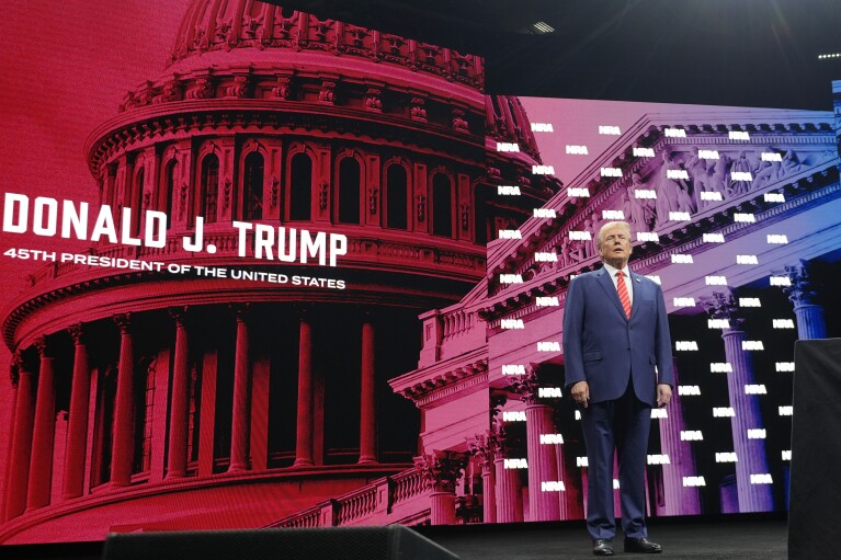 Former President Donald Trump stands on stage before speaking during the National Rifle Association Convention, Saturday, May 18, 2024, in Dallas. (AP Photo/LM Otero)