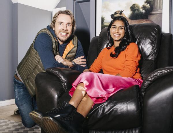 Co-hosts Dax Shepard, left, and Monica Padman of the podcast "Armchair Expert," pose in Los Angeles on Nov. 25, 2019. Shepard and Padman hope a new Spotify partnership expands their listenership globally. Beginning Thursday, the "Armchair Expert" library of 341 episodes plus new shows going forward and its companion series "Experts on Experts" will be exclusive to Spotify at no cost to listeners. (Michael Friberg via AP)