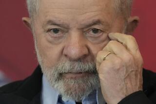 Brazil's former president who is running for reelection, Luiz Inacio Lula da Silva, looks on during the launch of his plan for the federal government, in Sao Paulo, Brazil, Tuesday, June 21, 2022. Brazil goes to the polls to elect a new president in October. (AP Photo/Andre Penner)