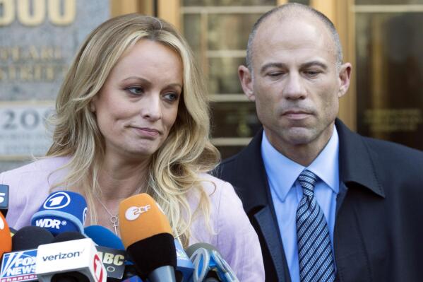 FILE- Adult film actress Stormy Daniels, accompanied by her attorney, Michael Avenatti, right, talks to the media as she leaves federal court, on April 16, 2018 in New York.The jury deliberating the fate of Michael Avenatti on charges that he ripped off his star client, Stormy Daniels, has told a judge that it is deadlocked on the first of two counts he faces. (AP Photo/Mary Altaffer, File)