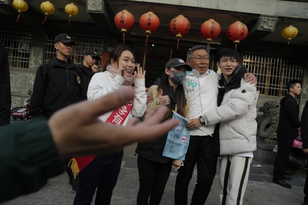 Ko Wen-je, Taiwan People's Party (TPP) presidential candidate, take photos with young supporters outside a temple in New Taipei City, Taiwan on Wednesday, Jan. 10, 2024. With Taiwan's high-stakes presidential election just days away, the nonconformist candidate has been resonating with the island's youth, seemingly more concerned with the dearth of good jobs and affordable housing than the looming threat from China. (AP Photo/Ng Han Guan)