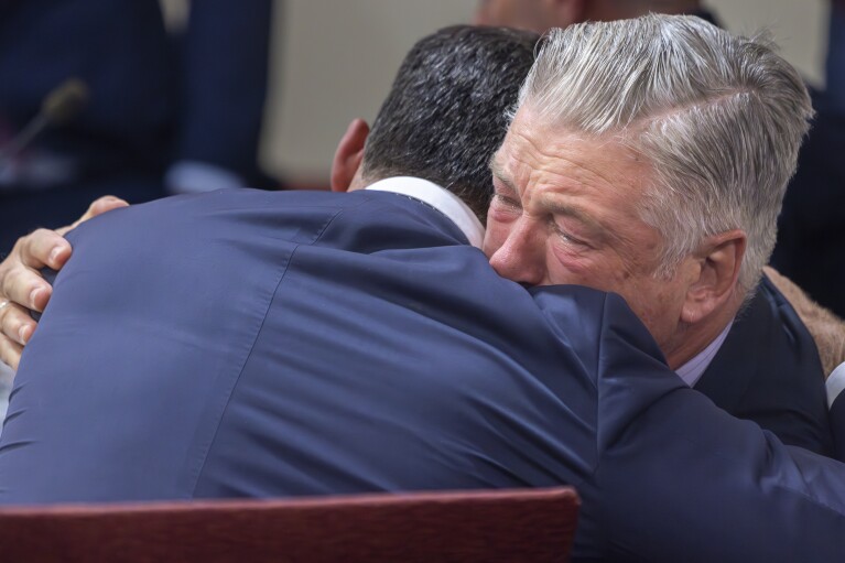 Actor Alec Baldwin, right, hugs his defense attorney Alex Spiro after District Court Judge Mary Marlowe Sommer threw out the involuntary manslaughter case for the 2021 fatal shooting of cinematographer Halyna Hutchins during filming of the Western movie "Rust," Friday, July 12, 2024, in Santa Fe, N.M. (Luis Sánchez Saturno/Santa Fe New Mexican via AP, Pool)